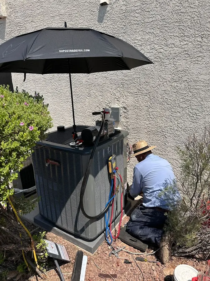 HVAC technician performing outdoor AC maintenance in Leisure City